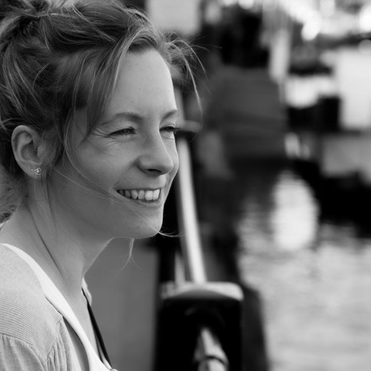 Anika Rao, Lead Design Curator at Quiet Orbit Studio, reviewing corporate floral arrangements